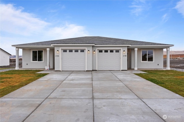 view of front of house featuring a garage and a front lawn