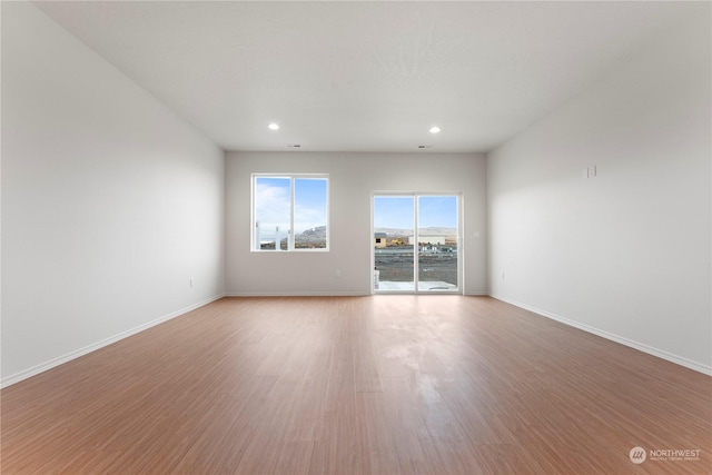 unfurnished room with light hardwood / wood-style floors