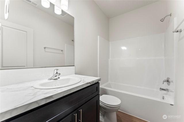 full bathroom with shower / tub combination, toilet, vanity, and hardwood / wood-style floors