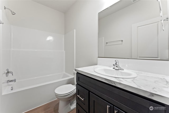 full bathroom featuring toilet, vanity, tub / shower combination, and hardwood / wood-style floors