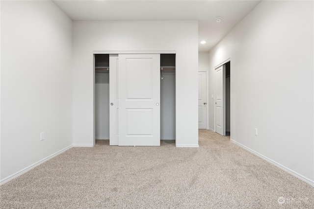 unfurnished bedroom featuring light carpet