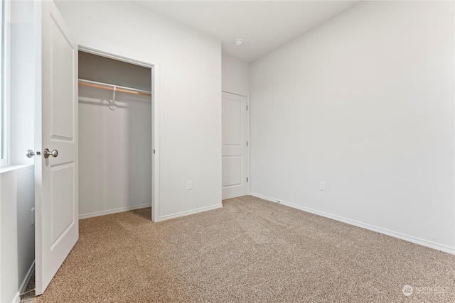 unfurnished bedroom with carpet floors and a closet