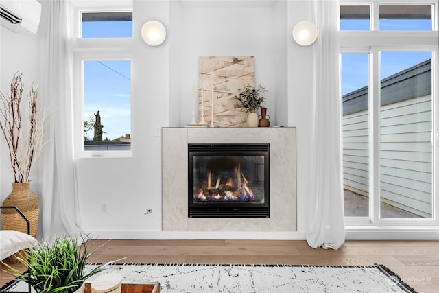 room details featuring a wall mounted AC and wood-type flooring