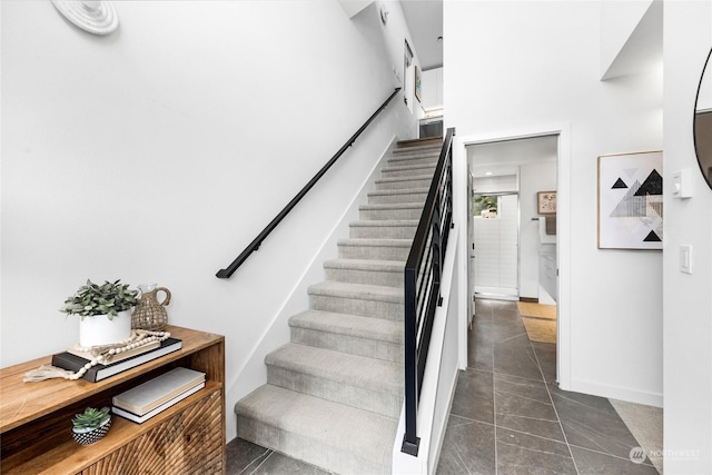 stairway featuring tile patterned flooring