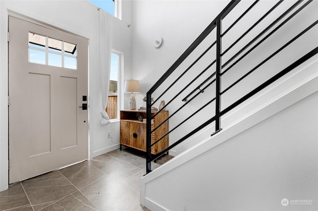 entryway featuring a towering ceiling