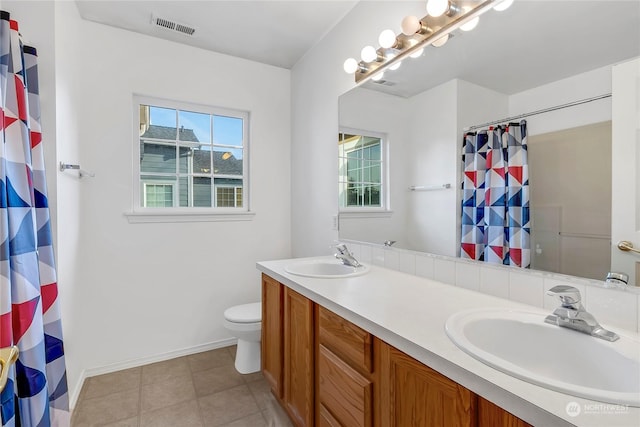 bathroom featuring curtained shower, toilet, vanity, and tile patterned flooring