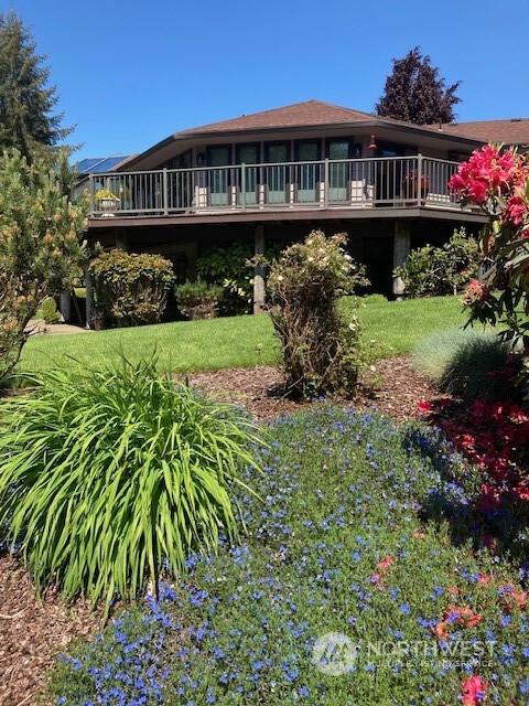 exterior space with a front lawn and a deck