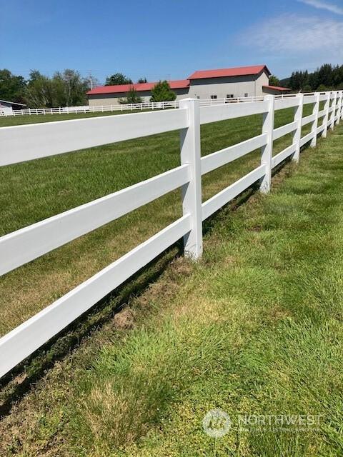 view of gate with a yard