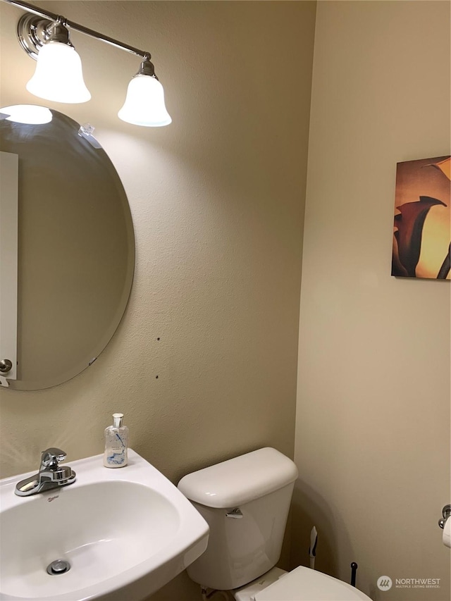 bathroom featuring toilet and sink