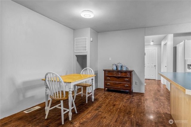 dining area featuring dark hardwood / wood-style floors