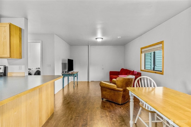 living room featuring washing machine and dryer and light hardwood / wood-style floors