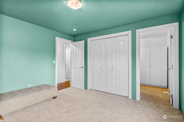 unfurnished bedroom featuring a closet and carpet