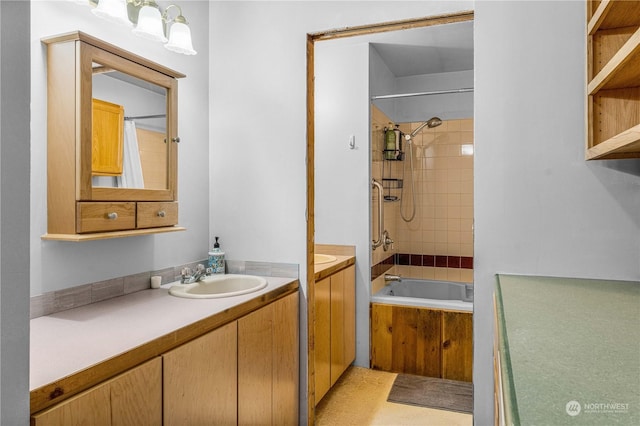 bathroom with tile patterned flooring, shower / bath combo with shower curtain, and vanity