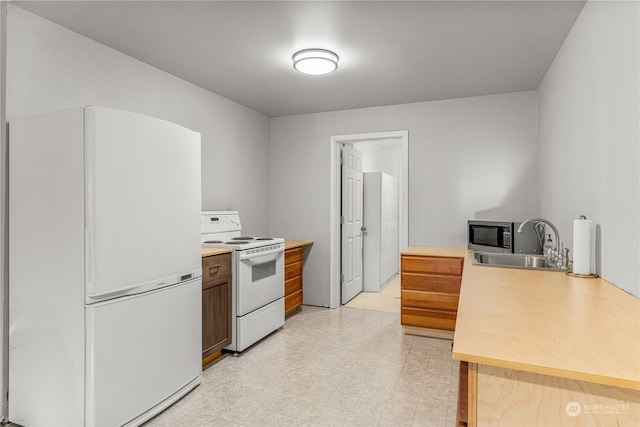 kitchen featuring sink and white appliances