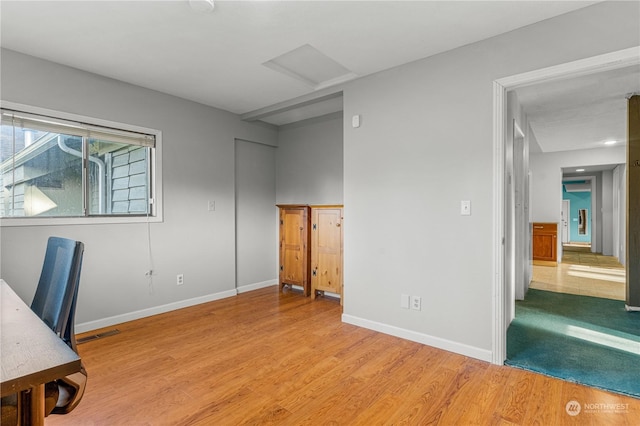 home office with light hardwood / wood-style floors