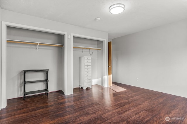 unfurnished bedroom featuring dark hardwood / wood-style flooring