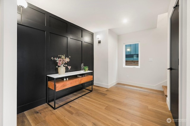 hallway with light hardwood / wood-style flooring