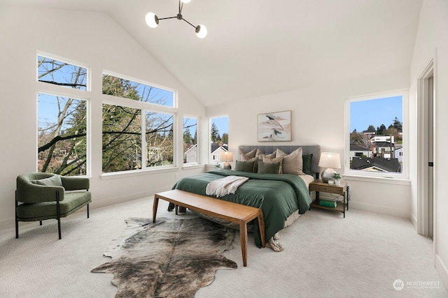 bedroom with light carpet, multiple windows, and high vaulted ceiling