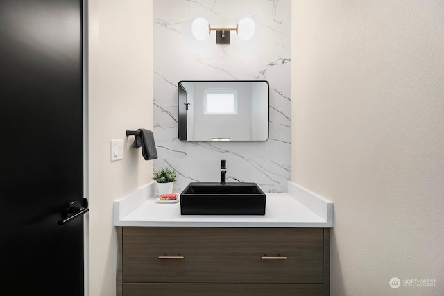 bathroom featuring vanity and backsplash