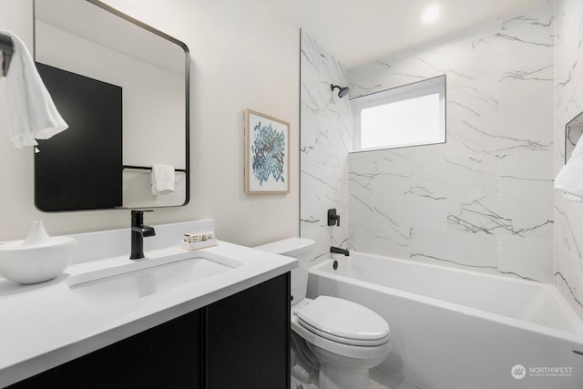 full bathroom featuring toilet, vanity, and tiled shower / bath