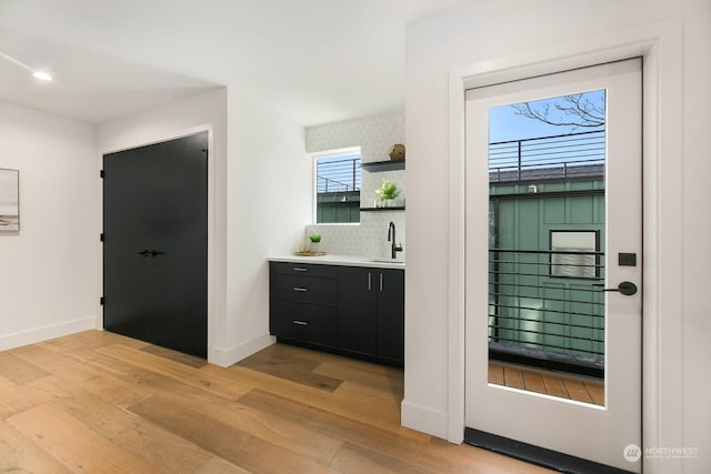 interior space with light hardwood / wood-style flooring and sink