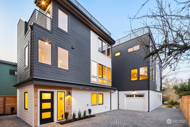 rear view of property with a garage