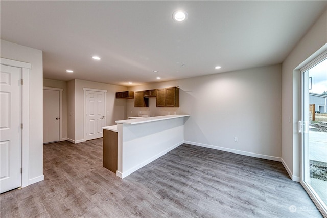 kitchen featuring light hardwood / wood-style flooring and kitchen peninsula