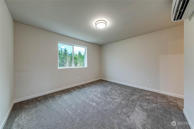 empty room featuring a wall mounted air conditioner and dark carpet