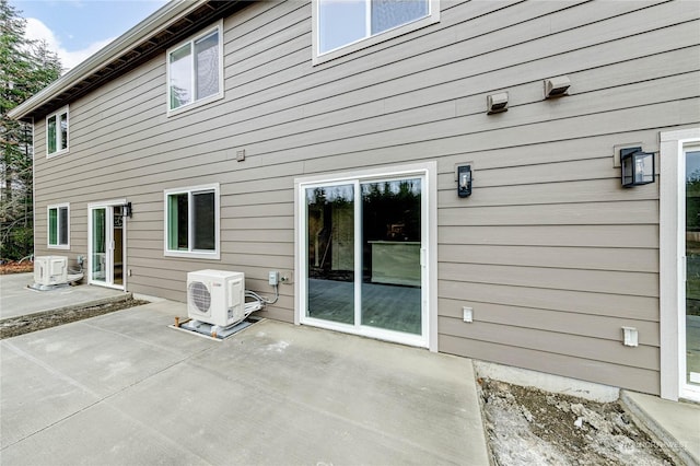 back of property featuring a patio and ac unit