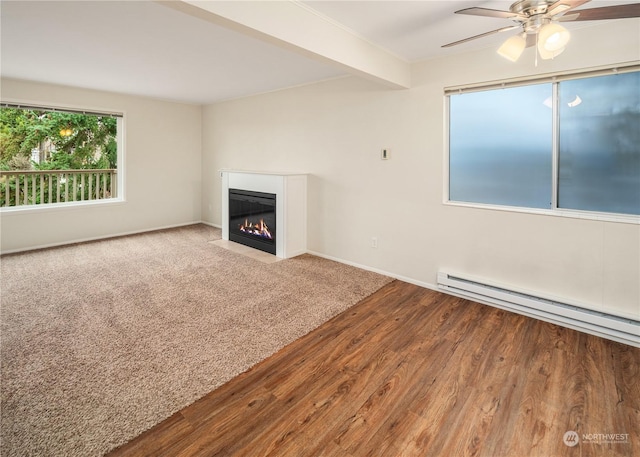 unfurnished living room featuring hardwood / wood-style flooring, baseboard heating, beam ceiling, and ceiling fan