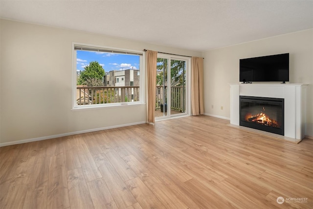 unfurnished living room with light wood-type flooring