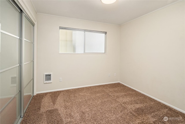 unfurnished bedroom with carpet floors, a closet, and ornamental molding