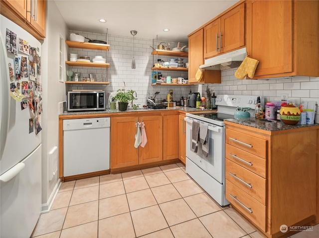 kitchen with white appliances, light tile patterned floors, and tasteful backsplash