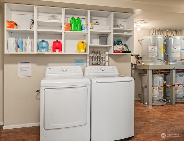 washroom with water heater, strapped water heater, independent washer and dryer, and dark hardwood / wood-style floors