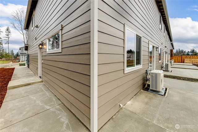 view of property exterior featuring ac unit and a patio