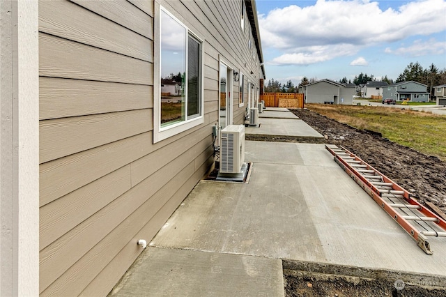 view of side of property featuring ac unit and a patio