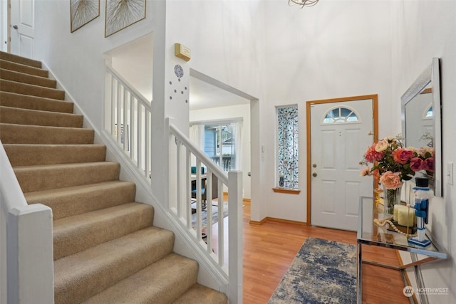 entrance foyer with wood-type flooring and a high ceiling