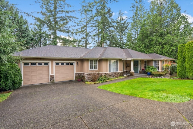 view of front of house featuring a front yard and a garage