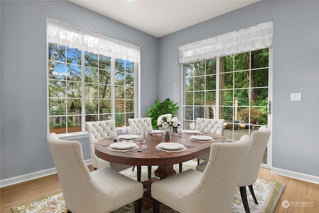 dining area with hardwood / wood-style flooring