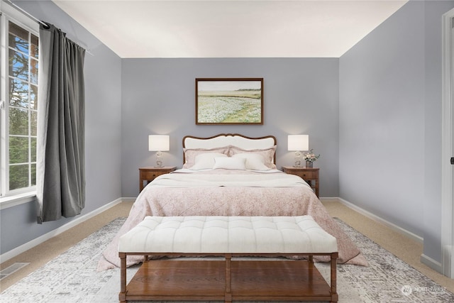 bedroom with light colored carpet