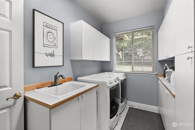 laundry area with sink, cabinets, and washer and dryer