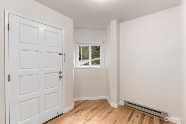 doorway to outside featuring light hardwood / wood-style floors and a baseboard radiator