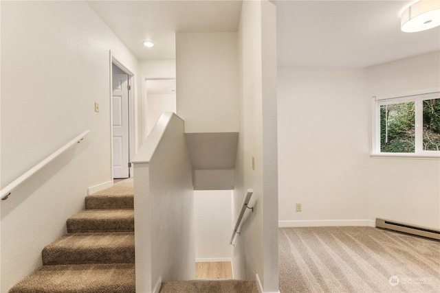 stairway featuring a baseboard radiator and carpet