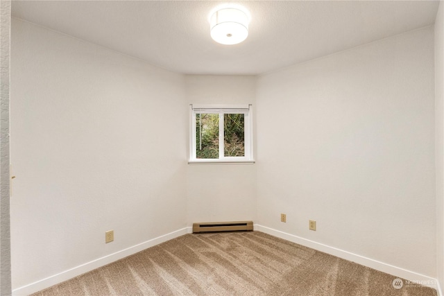 unfurnished room featuring a baseboard radiator and carpet