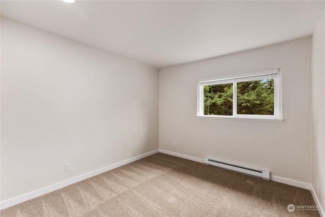 empty room with carpet flooring and a baseboard heating unit