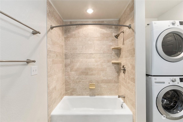 bathroom featuring stacked washing maching and dryer and tiled shower / bath combo