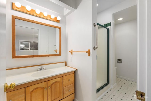 bathroom with vanity and a shower with shower door