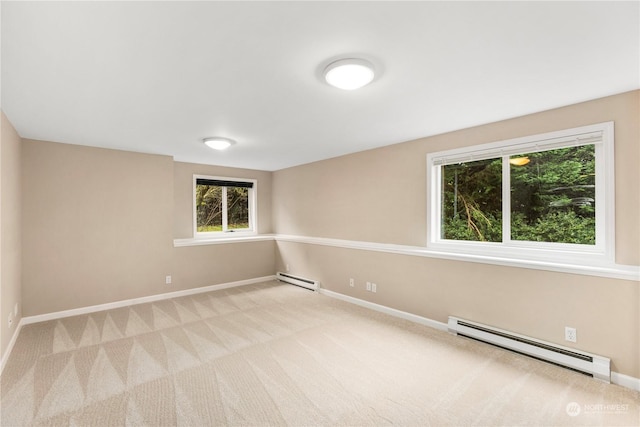 carpeted spare room featuring baseboard heating