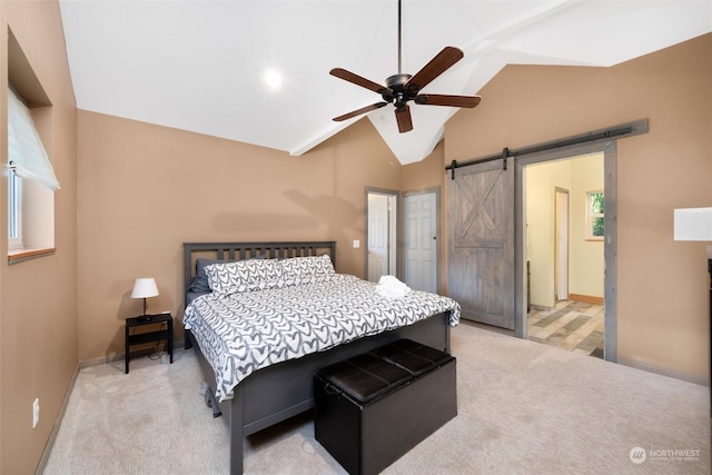 bedroom featuring ceiling fan, carpet floors, lofted ceiling, and a barn door