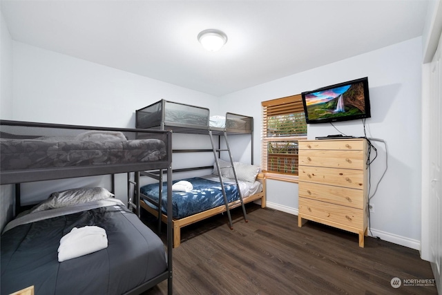 bedroom with dark wood-type flooring